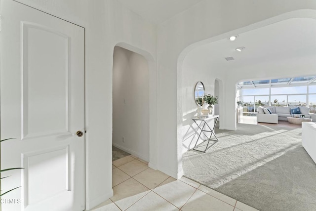 hall featuring light tile patterned flooring