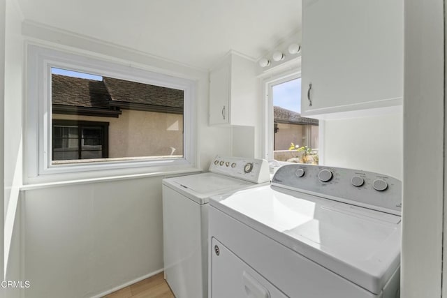 laundry area featuring washing machine and dryer and cabinets