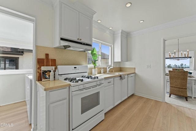 kitchen featuring white cabinetry, white appliances, light hardwood / wood-style floors, and crown molding