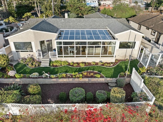 back of house featuring a sunroom and a yard