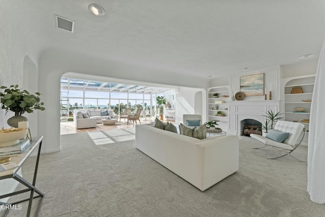 carpeted living room with built in shelves