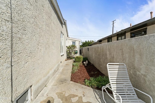 view of side of home with a patio