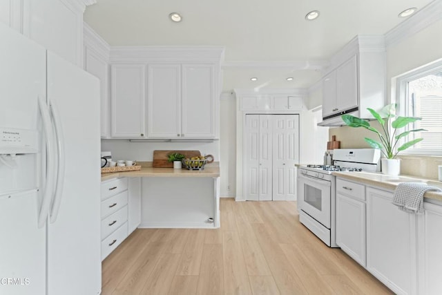 kitchen featuring white appliances, ornamental molding, light hardwood / wood-style flooring, and white cabinets