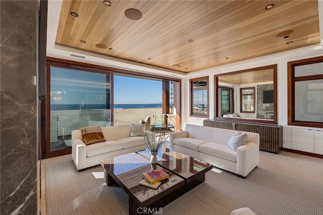 carpeted living area featuring a tray ceiling, wooden ceiling, and recessed lighting