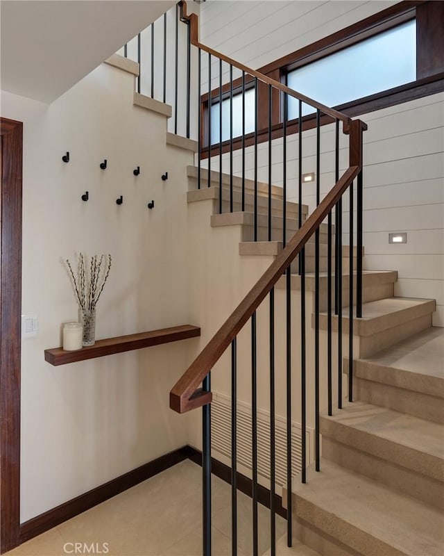 stairway featuring baseboards