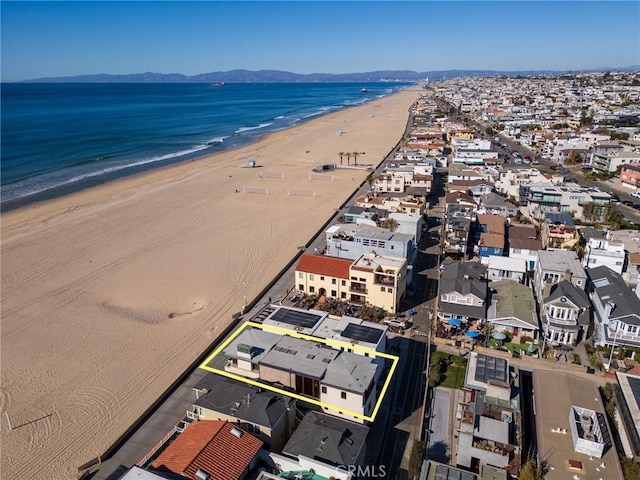 birds eye view of property featuring a water view and a view of the beach