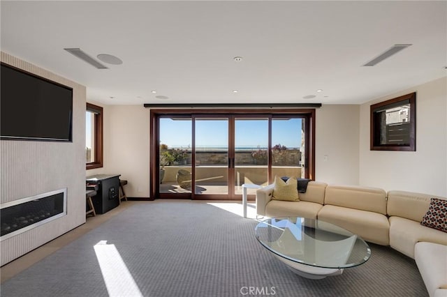 living area with visible vents and light colored carpet