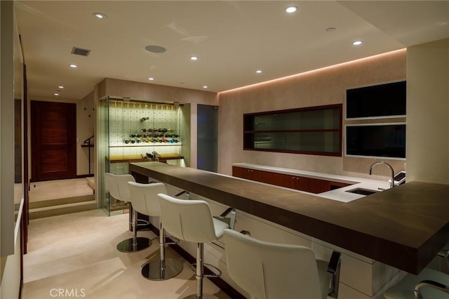 bar with light colored carpet, recessed lighting, visible vents, and a sink