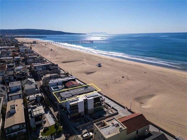 aerial view with a water view and a beach view