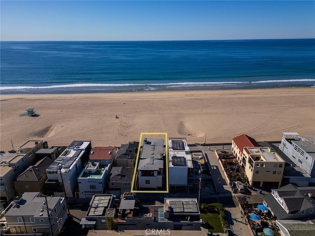 aerial view with a water view and a beach view