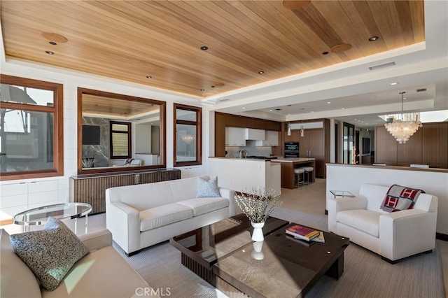 living room with wooden ceiling, visible vents, and a tray ceiling