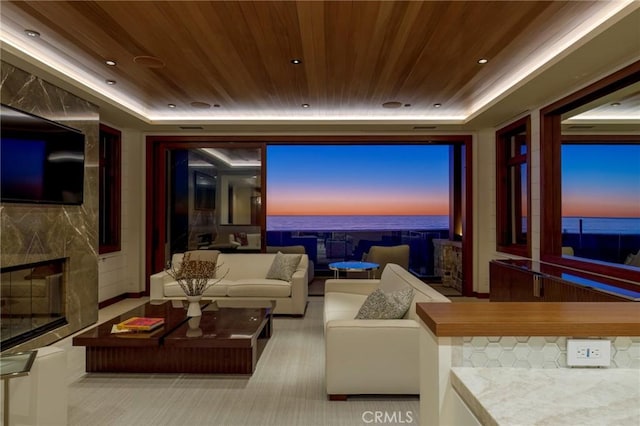 home theater room with a tray ceiling, a fireplace, wood ceiling, and recessed lighting