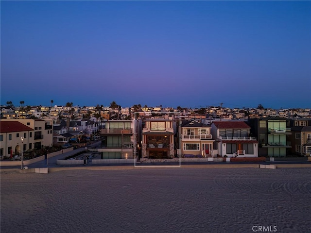 property at dusk with a residential view