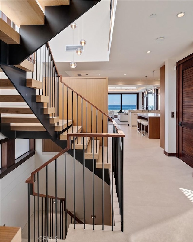 staircase featuring visible vents and recessed lighting