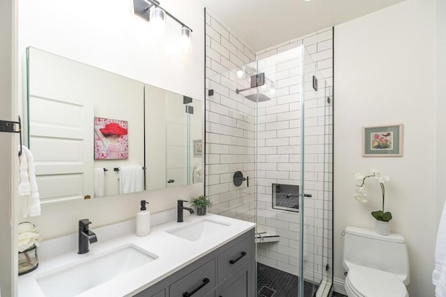 bathroom with walk in shower, vanity, and toilet