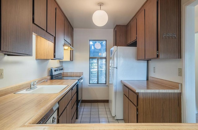 kitchen featuring pendant lighting, sink, stainless steel range with electric cooktop, light tile patterned flooring, and white fridge