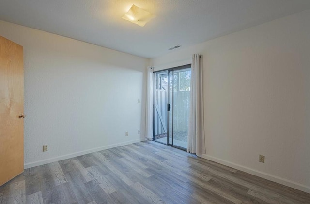 spare room with wood-type flooring