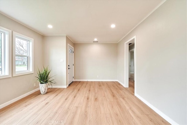 unfurnished room featuring crown molding and light wood-type flooring