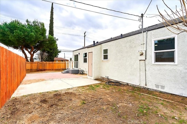 rear view of property featuring a patio area