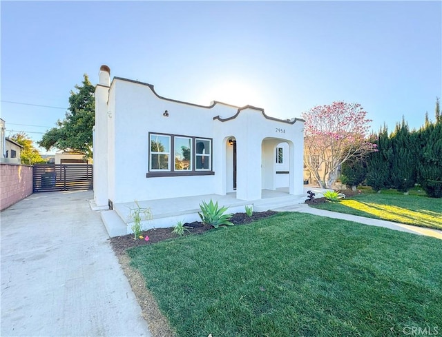 mediterranean / spanish-style house with a front lawn