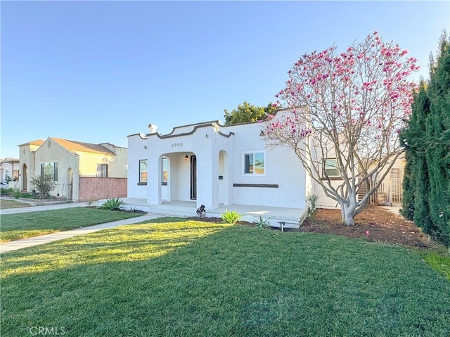 mediterranean / spanish house with a front lawn