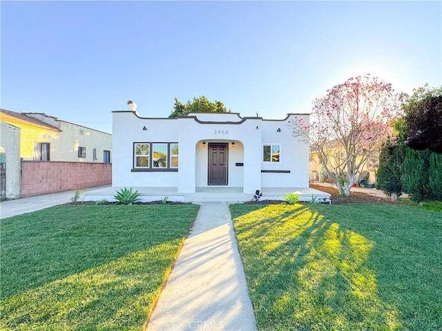 mediterranean / spanish home with a front lawn