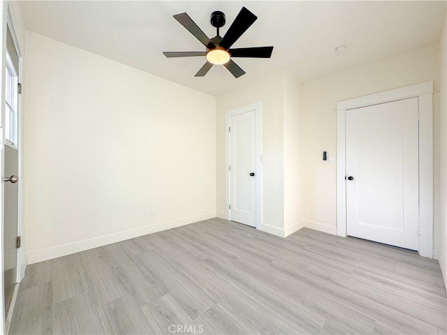 unfurnished bedroom with ceiling fan and light wood-type flooring