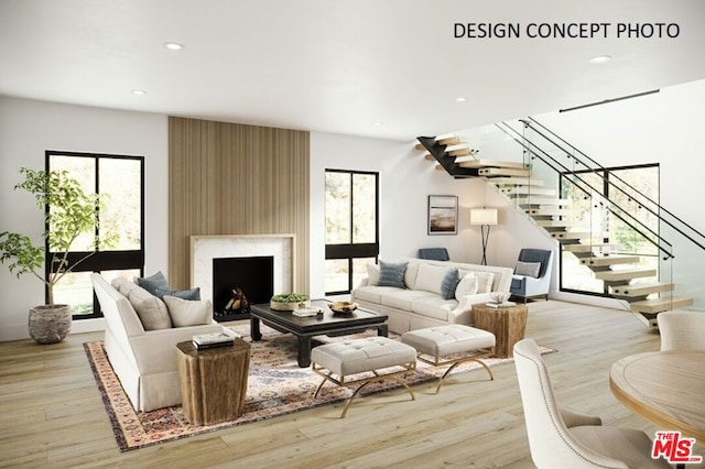 living room featuring a high end fireplace and light wood-type flooring