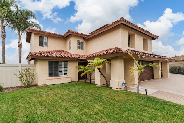 mediterranean / spanish-style house featuring a garage and a front lawn