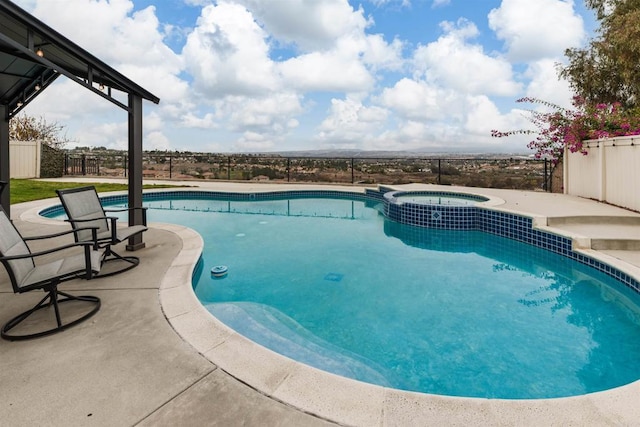 view of swimming pool with a patio area and an in ground hot tub