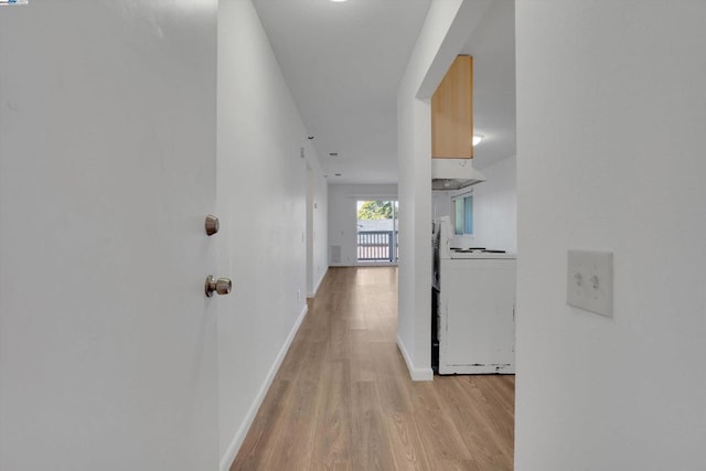 corridor with light hardwood / wood-style floors