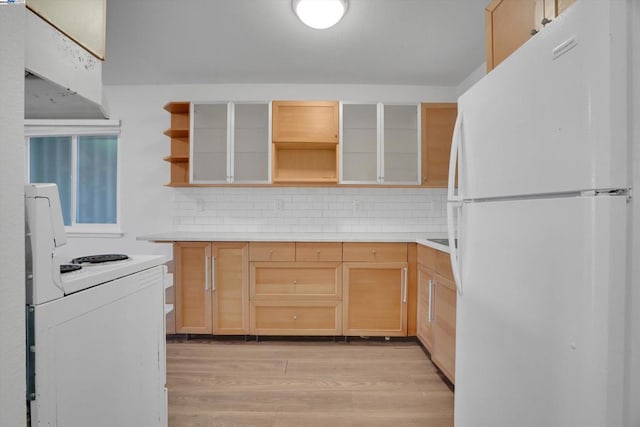 kitchen with white appliances, light wood-type flooring, tasteful backsplash, and light brown cabinets