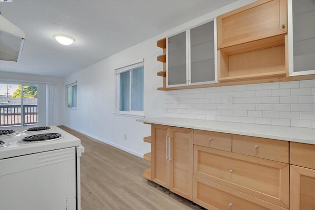 kitchen featuring light hardwood / wood-style floors, white electric stove, decorative backsplash, and light brown cabinets