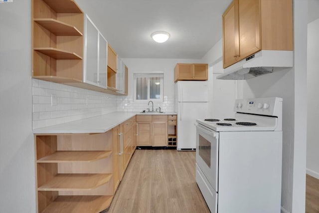 kitchen with white appliances, light brown cabinetry, light hardwood / wood-style floors, and sink