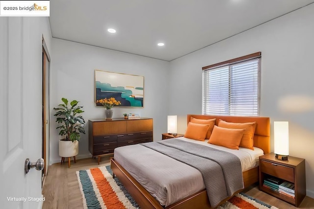 bedroom with hardwood / wood-style flooring