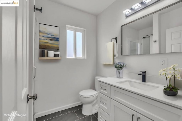 bathroom with toilet, tile patterned floors, and vanity