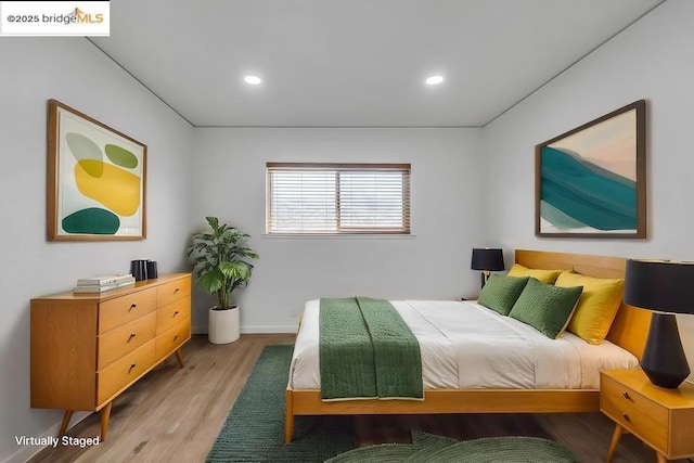 bedroom with hardwood / wood-style flooring