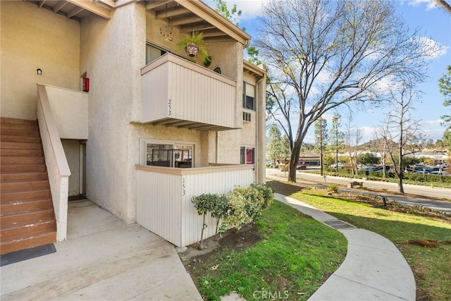 view of side of home with a balcony