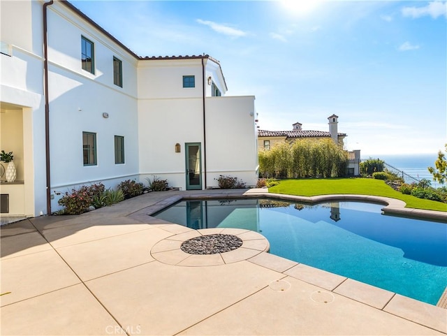 view of pool featuring a patio and a lawn