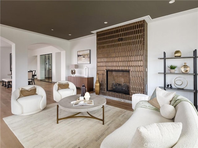 living room with hardwood / wood-style floors and a large fireplace