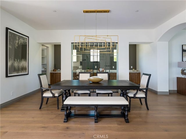 dining area featuring a notable chandelier and hardwood / wood-style flooring