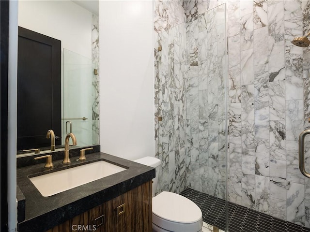 bathroom featuring toilet, walk in shower, and vanity