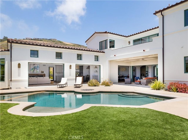 back of house with a yard, an outdoor hangout area, and a patio area