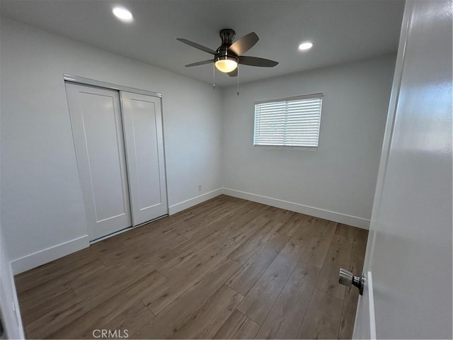 unfurnished bedroom with ceiling fan, a closet, and light hardwood / wood-style flooring