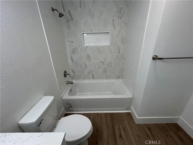 full bathroom with toilet, vanity, tiled shower / bath combo, and hardwood / wood-style flooring