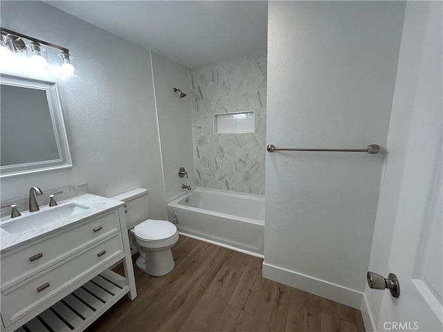 full bathroom with toilet, vanity, hardwood / wood-style floors, and tiled shower / bath