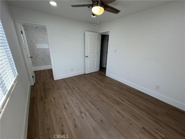 unfurnished bedroom with ceiling fan and wood-type flooring