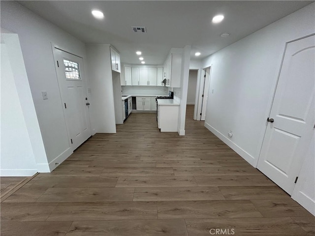 kitchen featuring white cabinetry and dark hardwood / wood-style floors