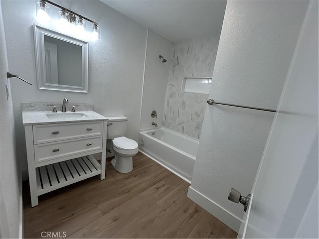 full bathroom with toilet, vanity, hardwood / wood-style flooring, and tiled shower / bath