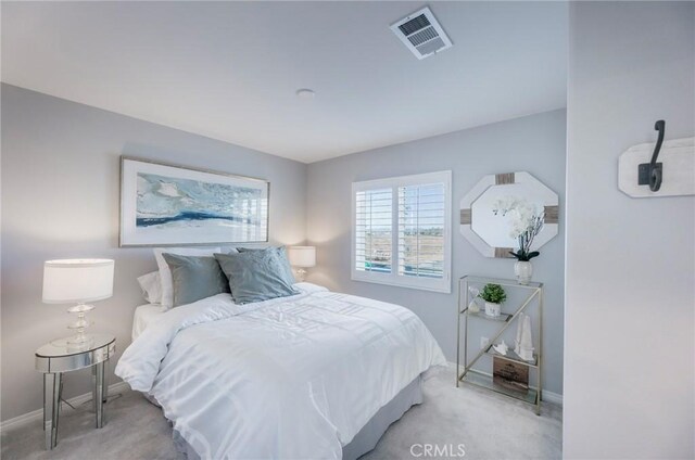 bedroom with light colored carpet